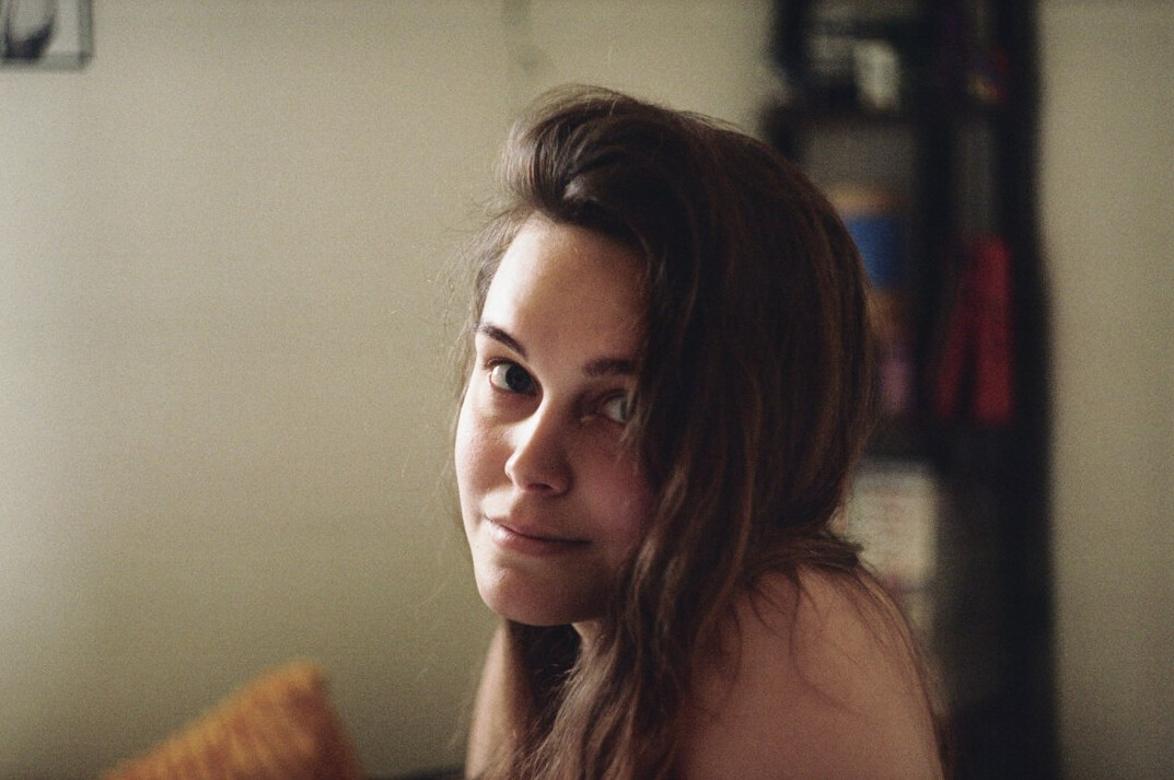 Portrait of a young woman with brown hair smiling